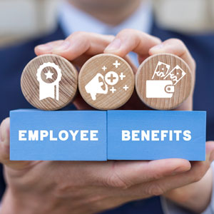 Hands holding blocks displaying 'Employee Benefits' with various icons.