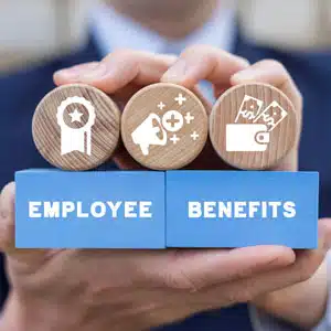 Hands holding blocks displaying 'Employee Benefits' with various icons.