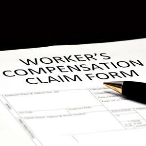 Pen resting on a WORKER'S COMPENSATION CLAIM FORM, for an on the job injury at a Florida waterpark