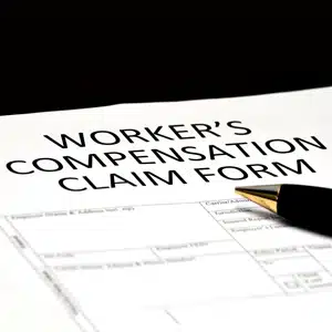 Pen resting on a WORKER'S COMPENSATION CLAIM FORM, for an on the job injury at a Florida waterpark