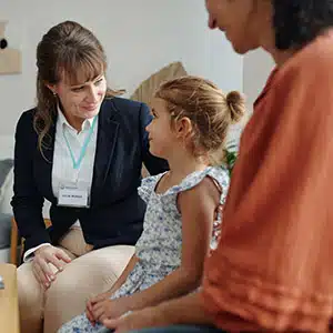 Consultant or lawyer talking to a mother and young daughter in a bright room,Childcare Florida.